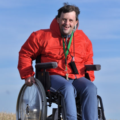 Special man in a wheelchair smiling
